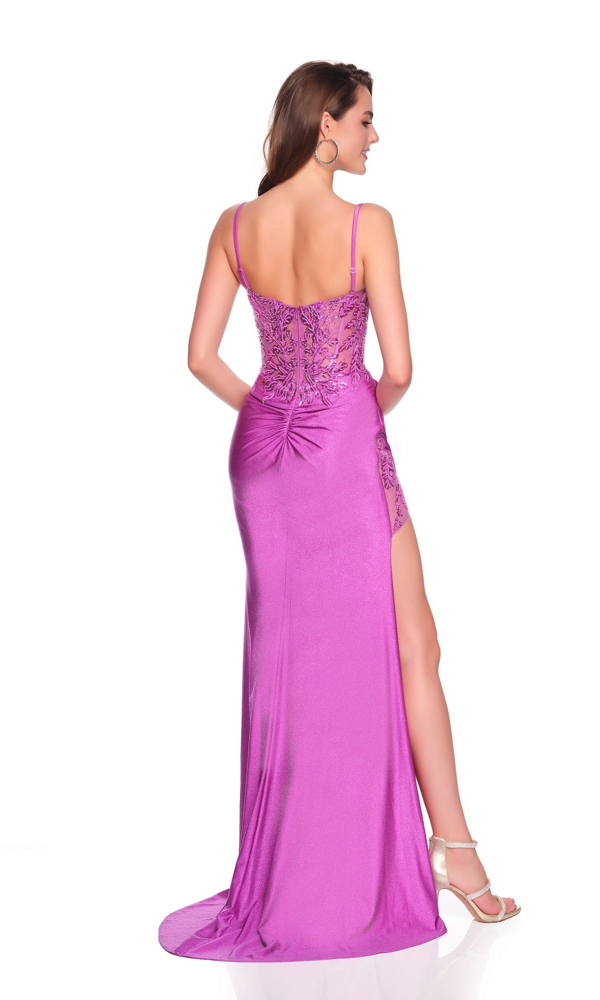 A woman faces away, wearing the Dave and Johnny 12770 long prom dress in deep purple with thin straps, a high-leg side slit, and white heels.